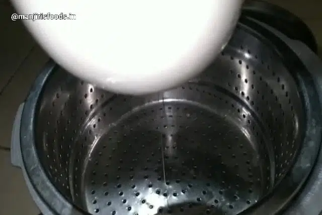 How to Make Shrikhand at Home A muslin cloth containg curd is hanged for draining excess water in a strainer