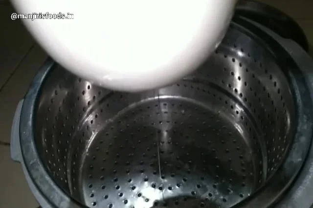 How to Make Shrikhand at Home A muslin cloth containg curd is hanged for draining excess water in a strainer
