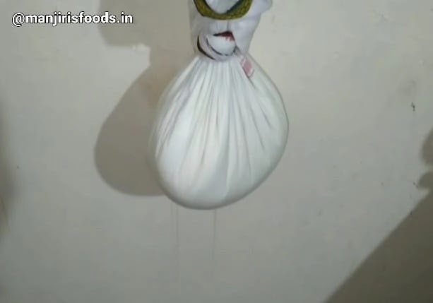 A muslin cloth containg curd is hanged for draining excess water