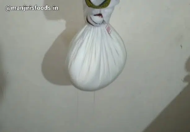 How to Make Shrikhand at Home A muslin cloth containg curd is hanged for draining excess water