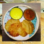 A serving plate containing Puris alongwith Shrikhand and Bhaji